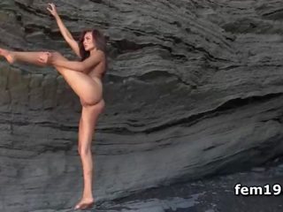 Delicate Mila K stretching naked by the sea